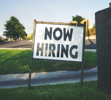 now hiring sign on lawn