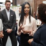 Business Team Standing Having Informal Meeting In Modern Office