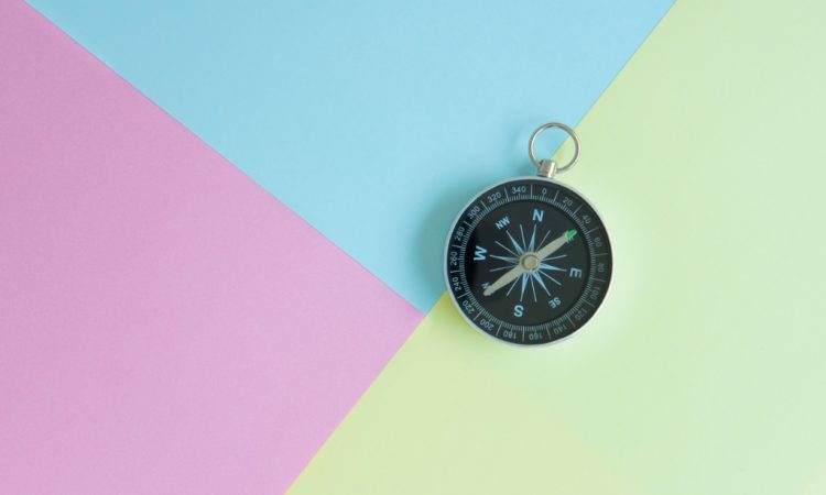 compass on multi-coloured background