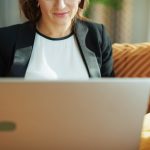 woman wearing blazer using laptop