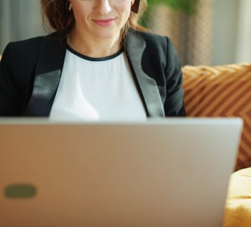 woman wearing blazer using laptop