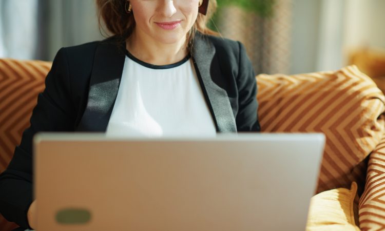 woman wearing blazer using laptop