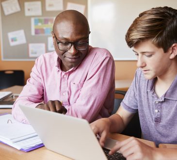 male tutor and student working together