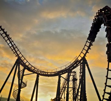 Roller coaster on sunset sky.
