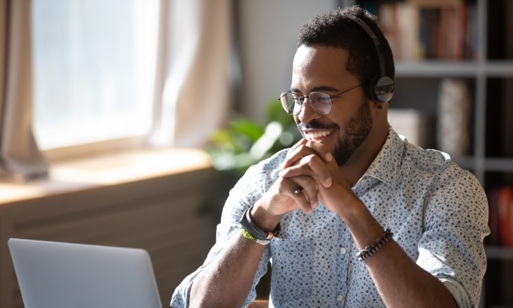 man watching webinar on laptop