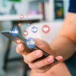 Hand using smart phone with Social media concept