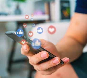 Hand using smart phone with Social media concept