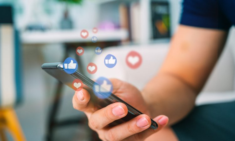 Hand using smart phone with Social media concept