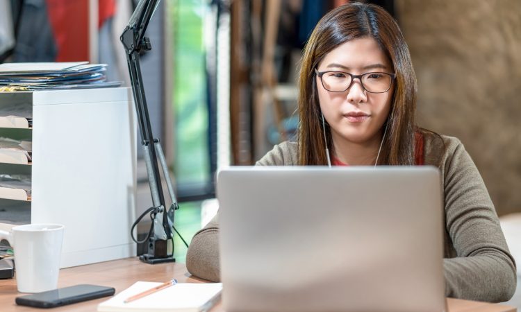 woman watching webinar on laptop