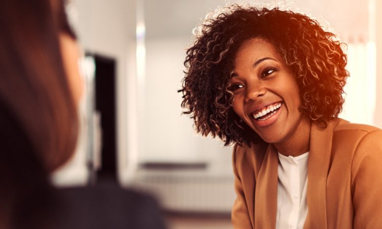 young black businesswoman talking to coworker