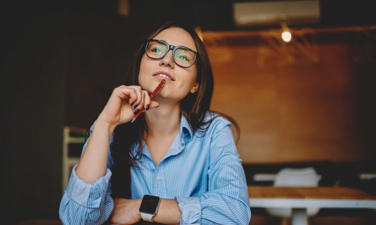 woman sitting at desk thinking