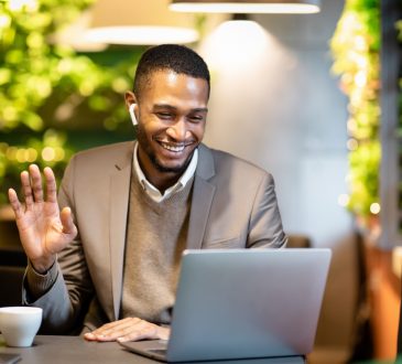 businessman watching video on screen and waving