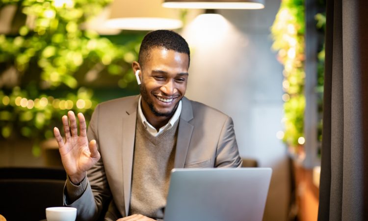 businessman watching video on screen and waving