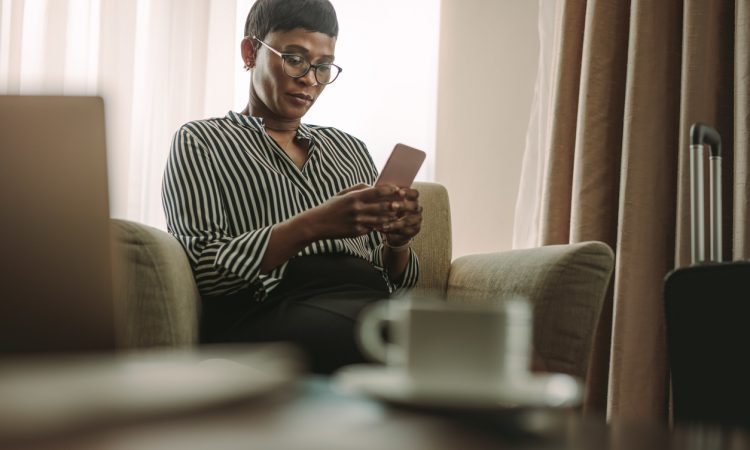 woman reading on cellphone on couch