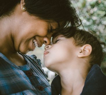 mom smiling down at son