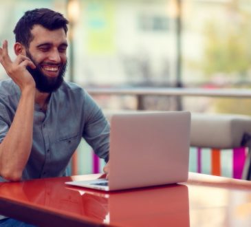 man smiling at laptop