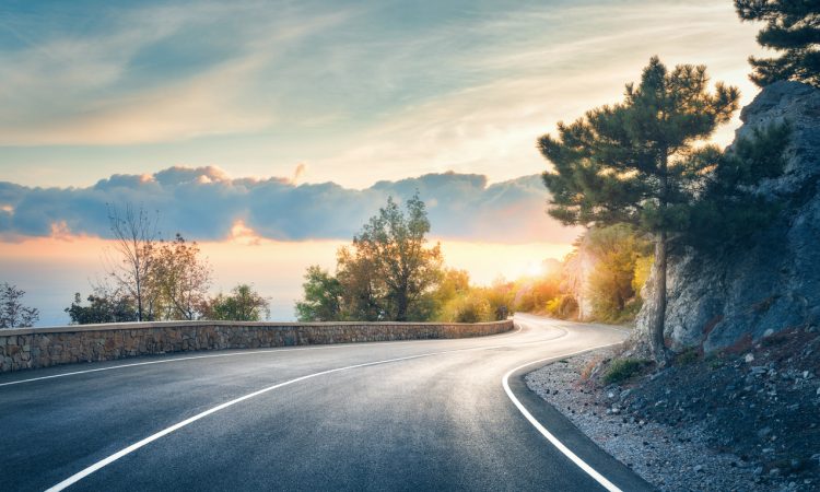 Highway in mountains beside lake