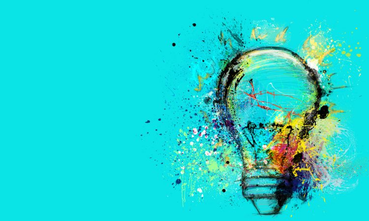 Big stylized light bulb on cyan background drawn with splashes of colored paint.