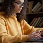 female student working on computer