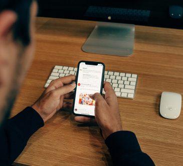 man scrolling through social media on cellphone