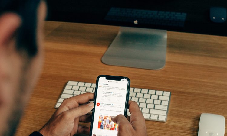 man scrolling through social media on cellphone