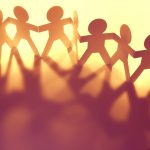 chain of paper people holding hands