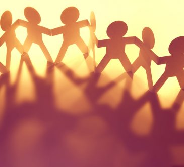 chain of paper people holding hands