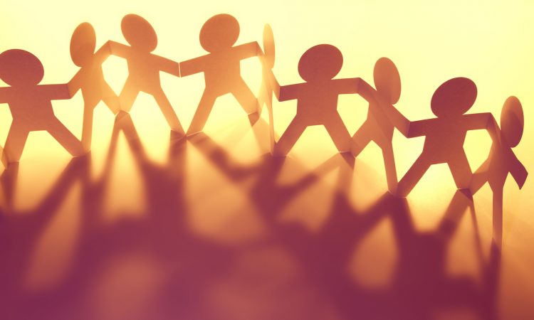 chain of paper people holding hands