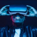 man smiling and wearing virtual reality headseat