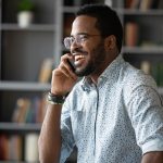 man having work phone call looking happy