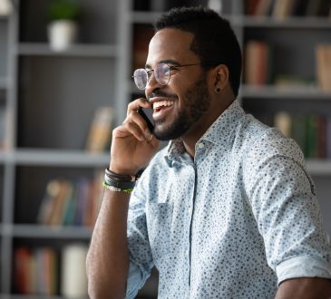 man having work phone call looking happy