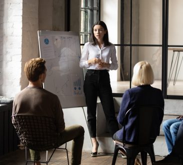 woman giving presentation to colleagues