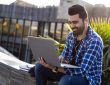 Male student Outdoors on laptop