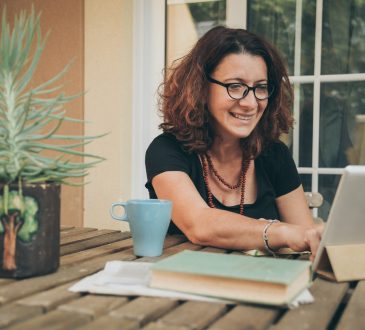 woman working on laptop on table outdoors