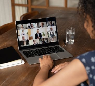 woman on video call at kitchen table