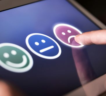 smiley, neutral and sad faces on screen for customer selection