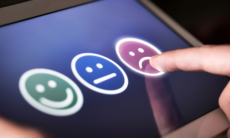 smiley, neutral and sad faces on screen for customer selection
