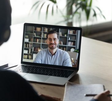woman watching webinar on laptop