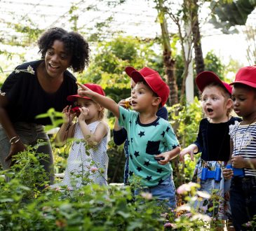 Teacher and kids learning gardening