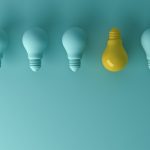 blue lightbulbs in a row with one yellow one facing the other way