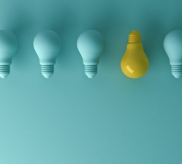 blue lightbulbs in a row with one yellow one facing the other way