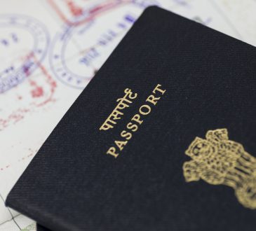 Close up of Indian passport stacked on white background.