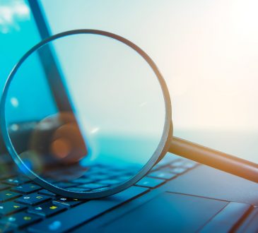 Laptop computer with magnifying glass on keyboard