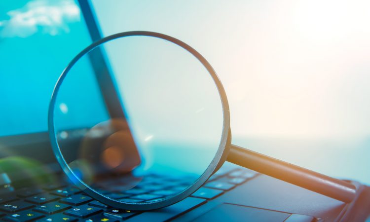 Laptop computer with magnifying glass on keyboard