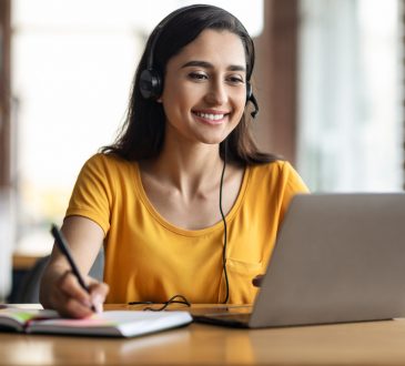 Woman watching webinar on laptop.