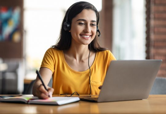 Woman watching webinar on laptop.