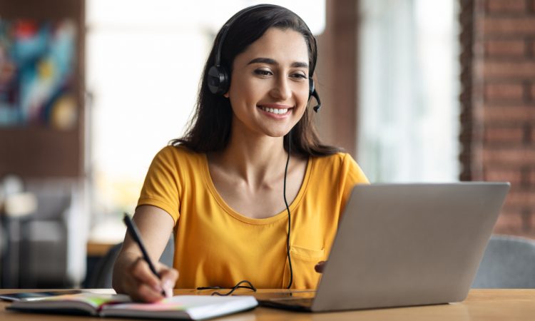 Woman watching webinar on laptop.