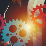 Teamwork of businesspeople work together and combine pieces of gears.