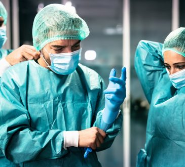 Three doctors preparing for surgery.