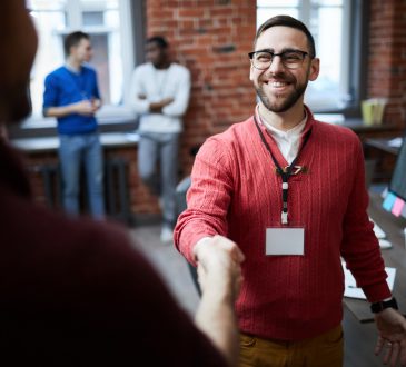 Two people shaking hands at work.
